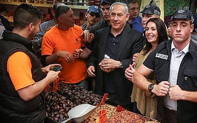 Prime Minister and head of the Likud party Benjamin Netanyahu seen with Likud member Miri Regev during a visit at the Jerusalem Mahane Yehuda market on March 9, 2015. (photo credit: Flash90)