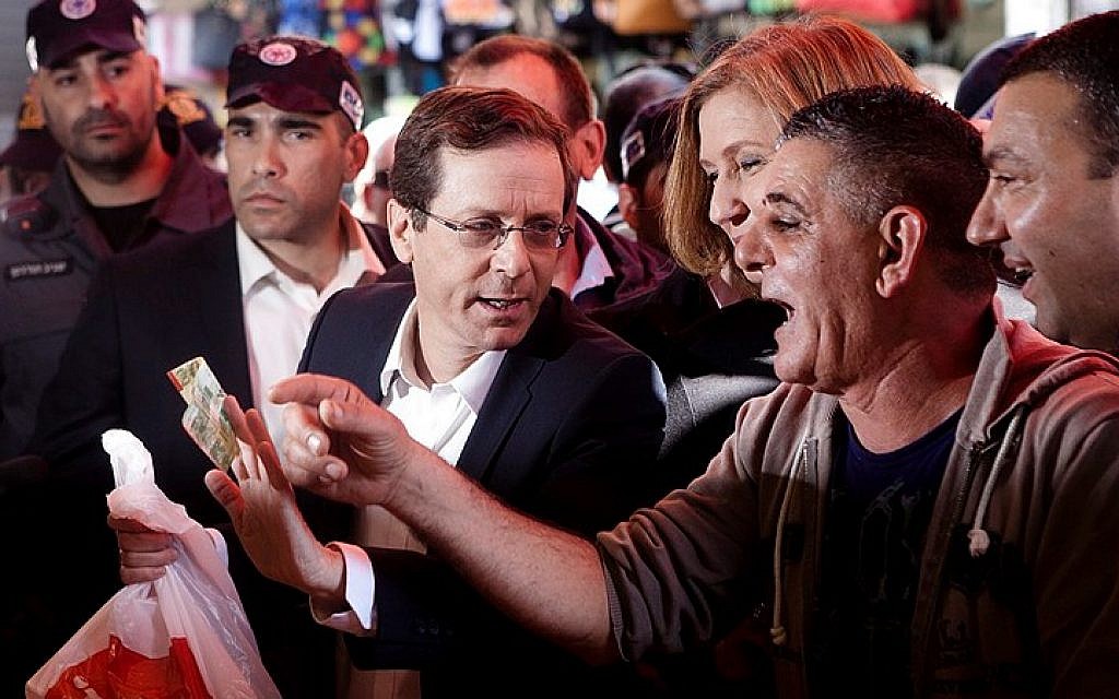 Isaac Herzog and Tzipi Livni seen during a campaign tour at Shuk Hacarmel market in Tel Aviv, March 12, 2015. (photo credit: Amir Levy/Flash90)