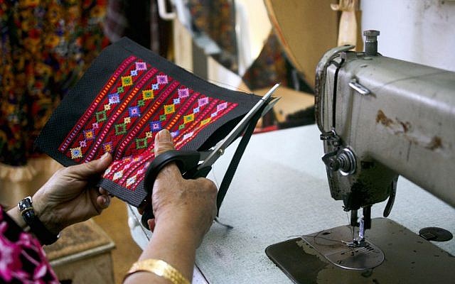 Najla finishes embroidered products in the evening (photo credit: Shaina Shealy/Times of Israel