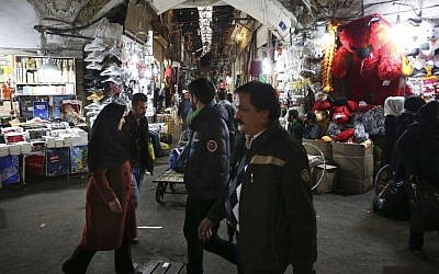 Iranians walk through Tehran's old main bazaar in Iran, November 25, 2014. (photo credit: AP/Vahid Salemi) 