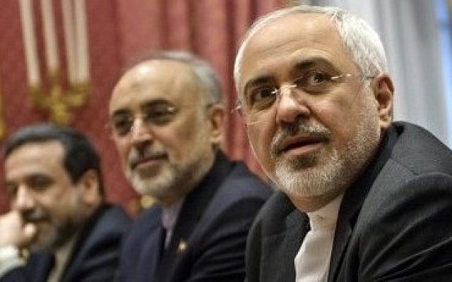 Iranian Foreign Minister Mohammad Javad Zarif (right), waits for the start of a meeting with a US delegation to multilateral nuclear talks at a hotel in Lausanne, Switzerland, on March 26, 2015. (photo credit: AP/Brendan Smialowski)
