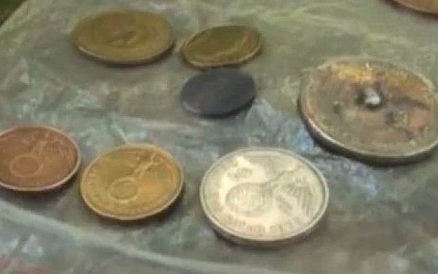German coins, dating to the Nazi era, discovered at a remote location in Argentina believed to have been built as a hideout for Nazi war criminals. (screen capture: YouTube/AllNews)