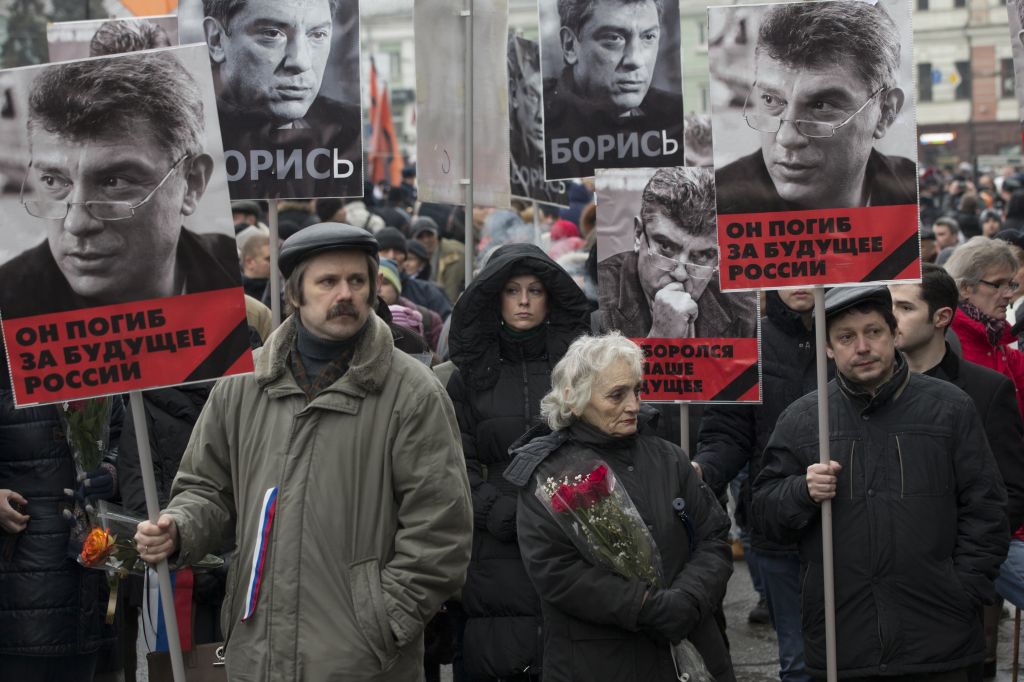 People carry portraits of opposition leader Boris Nemtsov, who was gunned down on Friday, February 27, 2015 near the Kremlin. (photo credit: AP Photo/Pavel Golovkin)
