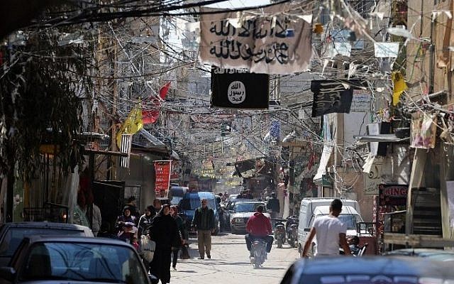 Electric cables and Islamist flags hang over a street dominated by Islamists factions in the refugee camp of Ain Al-Helweh, near the southern Lebanese city of Sidon, on March 16, 2015. (photo credit: AFP/JOSEPH EID)
