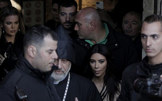 US reality TV star Kim Kardashian (C-R) and her sister Khloe (L), are pictured following a reported baptism ceremony for Kim's daughter North West, at the Armenian St. James Cathedral in Jerusalem's Old City on April 13, 2015. (AFP / AHMAD GHARABLI)