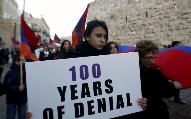 Members of the Armenian community march with flags and torches on April 23, 2015, in Jerusalem's Old City, on the eve of the 100th anniversary of the mass killings of Armenians under the Ottoman Empire in 1915. (photo credit: AFP/Gali Tibbon)