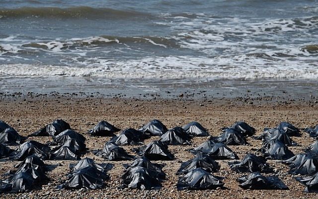 'Body bags' appear on Brighton beach in southern England, on April 22, 2015, in a display by Amnesty International to highlight what they claim is Britain's shameful response to the refugee and migrant crisis in the Mediterranean. (Ben Stansall/AFP)