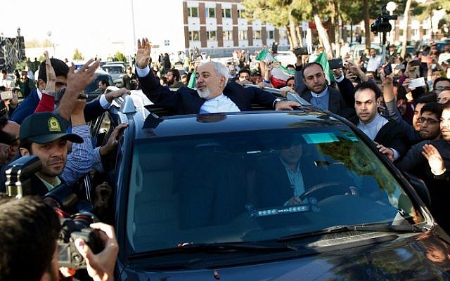 Iranian Foreign Minister Mohammad Javad Zarif greets people as the nuclear negotiating committee arrives at Mehr Abad Airport in Tehran on April 3, 2015, hours after announcing the ingredients of a nuclear deal with world powers. (photo credot: AFP/ISNA/Borna Ghasemi)