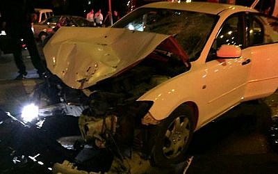 Police investigate a car that struck a bus stop on Apr. 15, 2015 in Jerusalem's French Hill, which killed one and seriously injured another.  (Photo credit: Fire and Rescue Services)