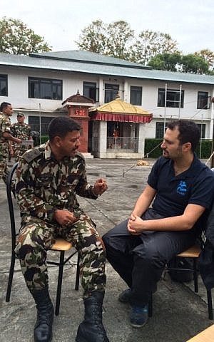 Yotam Polizer, IsraAID's Head of Mission and IsraAID Asia Director, speaks with a Nepalese army official, in a picture released by IsraAID on Tuesday, April 28, 2015. (Photo credit: Courtesy IsraAID)