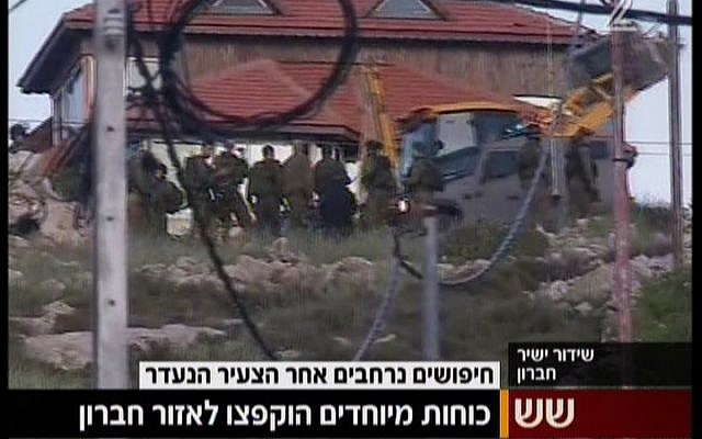 IDF soldiers outside the West Bank village of Beit Anun, near Hebron, searching for an Israeli man who went missing on April 2, 2015. (screen capture: Channel 2)