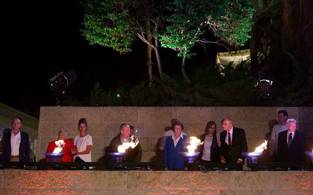 Illustrative: Survivors, some accompanied by their children or grandchildren, light six torches at Yad Vashem on the eve of Holocaust Remembrance Day in 2017. (Yonatan Sindel/ Flash 90)