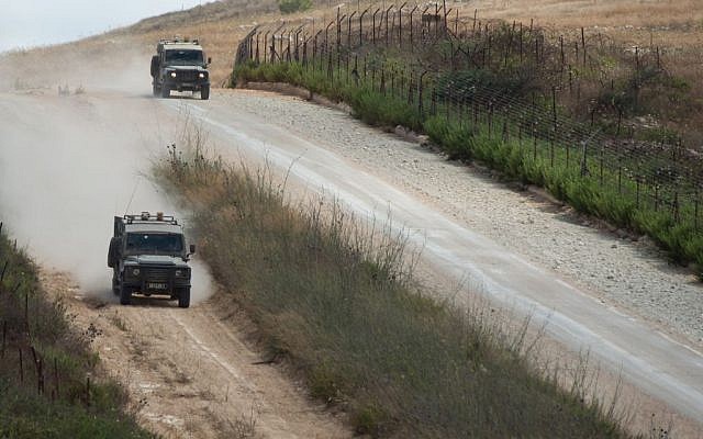 Israeli army jeeps patrol along the northern Israeli border with Lebanon on July 14, 2014. (Ayal Margolin/Flash90)