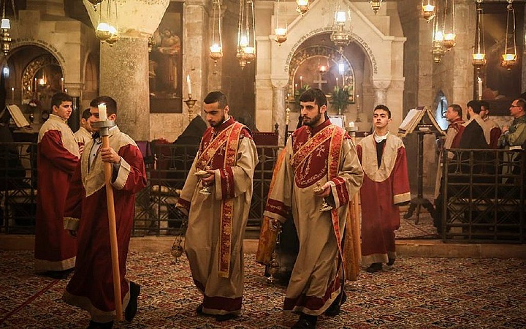 Armenian Christian clergymen attend prayers on Palm Sunday, in the Church of the Holy Sepulchre, in Jerusalem's Old City, April 5, 2015. (Photo credit: Hadas Parush/FLASH90)