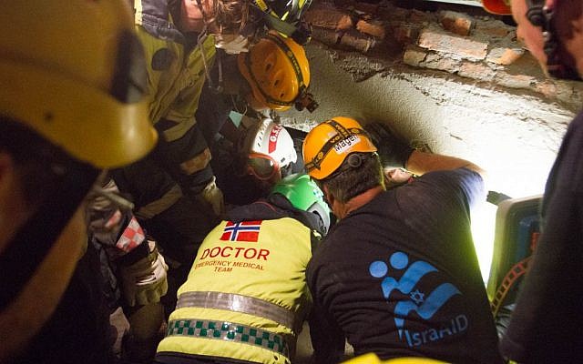 An Israeli-led team of rescuers works to extract a Nepalese woman from under the rubble of a collapsed hotel in Kathmandu on Thursday, April 30, 2015 (photo credit: IsraAID/Mickey Noam Alon)