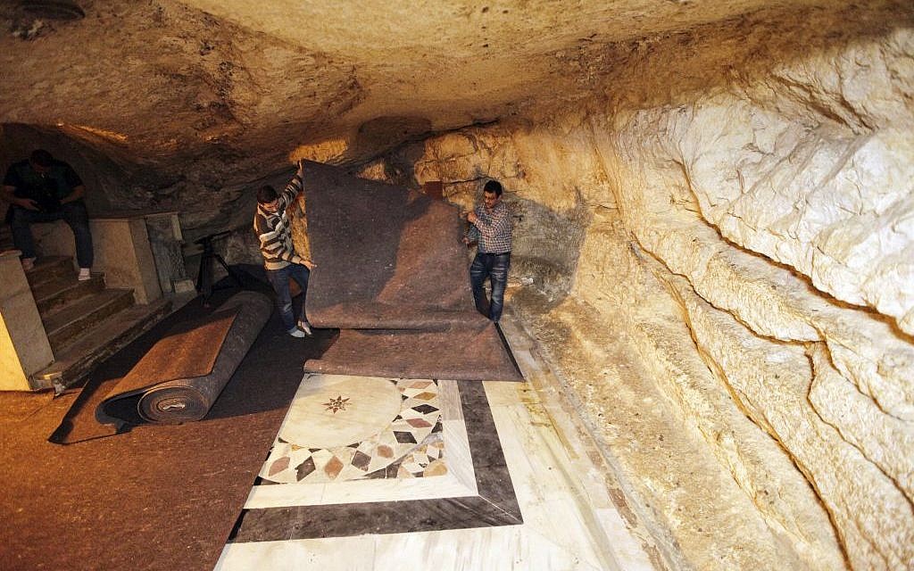 In this Sunday, April 19, 2015 photo, workers place carpets over ancient floor designs in the cave under the Dome of the Rock shrine in Jerusalem. The Dome of the Rock enshrines the large rock slab where Muslim tradition says Mohammed ascended to heaven. Jews believe the rock may be where the holiest part of the two ancient temples stood about 2,000 years ago. (photo credit: AP/Mahmoud Illean)