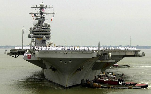 In this May 29, 2003 file photo, sailors man the rails as the USS Theodore Roosevelt is maneuvered into its berth at the Norfolk Naval Station in Norfolk, Va. (AP Photo/Steve Helber, File)