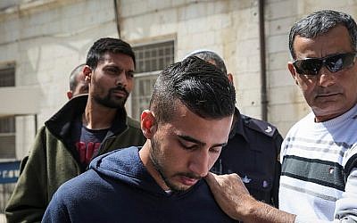 Niv Asraf (C) and his friend Eran Negauker (L), 22-year-olds from Beersheba, are seen at the Jerusalem Magistrate's Court for remand extension on April 3, 2015, a morning after Asraf was found in Kiryat Arba after being falsely reported as missing (Hadas Parush/Flash90) 