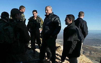 Prime Minister Benjamin Netanyahu during a February  4, 2015, visit to an army position on Mount Hermon (photo credit: AP Photo/ Baz Ratner, pool)