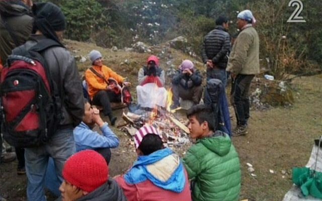 Israeli hikers and Nepalese await rescue in the Langtang region of Nepal in a picture published on April 28, 2015. (Screen capture: Channel 2)