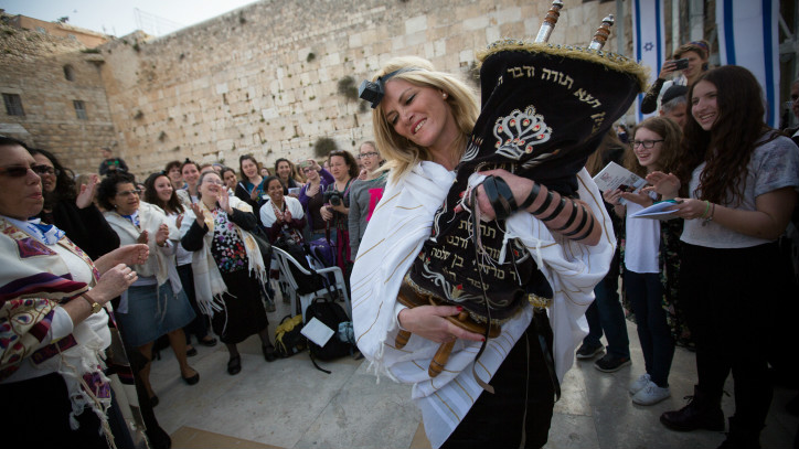 Women dance with a Torah scroll as they attend a monthly prayer service at the Western Wall, Judaism's holiest site, on April 20, 2015 (photo credit: Miriam Alster/Flash90) 