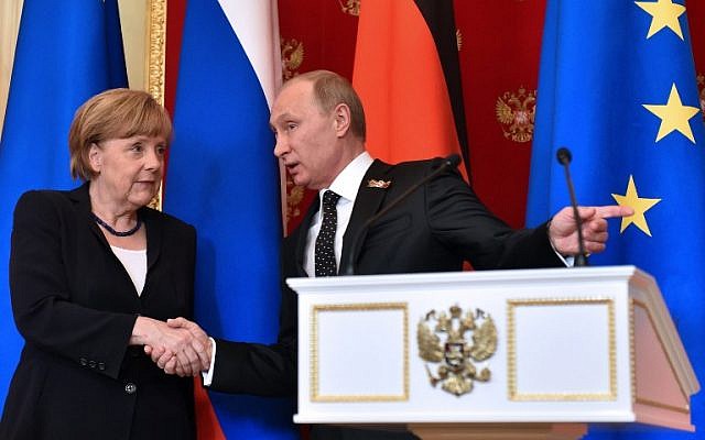 Russian President Vladimir Putin (R) shows the way to German Chancellor Angela Merkel as they leave a hall after a joint press conference at the Kremlin in Moscow on May 10, 2015. (photo credit: AFP PHOTO / KIRILL KUDRYAVTSEV)