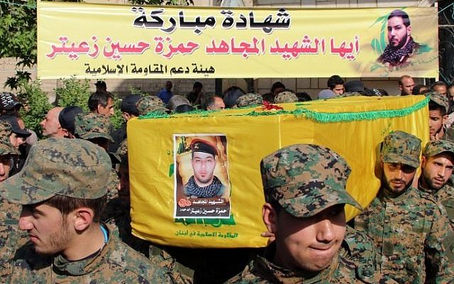 Hezbollah fighters carry the coffin of fellow Shiite fighter Hamza Hussein Zeiter during his funeral on May 5, 2015 in the town of Baalbek in eastern Lebanon's Bekaa Valley. The Hezbollah fighter was killed during clashes with members of Al-Nusra Front in the Syrian region of Qalamoun. (AFP)