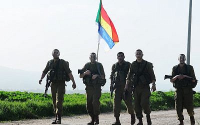 Soldiers from the soon-to-be disbanded Battalion 299 in the field with the Druze flag (Courtesy/ IDF Flickr)