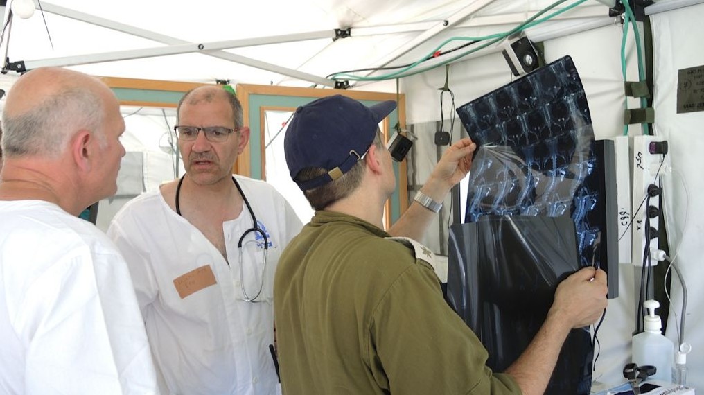 Israeli doctors examine X-rays of a patients’ pelvis at the IDF field hospital in Kathmandu (Photo credit: Melanie Lidman)