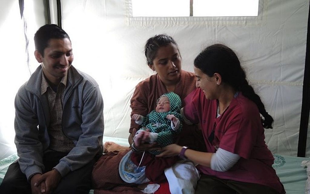 Israeli midwife Dganit Gery sits with Lata and Harendra Chang, whose baby was delivered at the IDF field hospital in Kathmandu on Friday, May 1, 2015. (Photo credit: Melanie Lidman)
