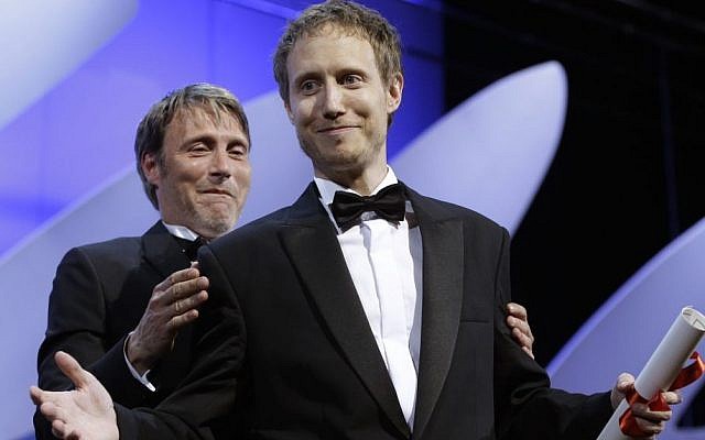 Director Laszlo Nemes, right, is presented the Grand Prix award by actor Mads Mikkelsen for the film Son of Saul during the awards ceremony at the 68th international film festival, Cannes, southern France, Sunday, May 24, 2015. (AP Photo/Lionel Cironneau)