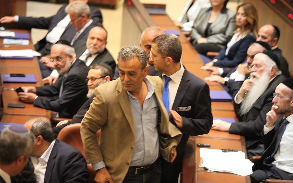 MK Jamal Zahalka is removed from the Knesset plenum after making repeated catcalls during a speech by Prime Minister Benjamin Netanyahu on Thursday, May 14, 2015 (Knesset spokesperson)