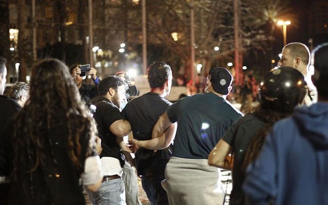 Police arrest a demonstrator at a protest in Tel Aviv's Rabin Square on Sunday, May 3, 2015. (photo credit: Judah Ari Gross/Times of Israel staff)