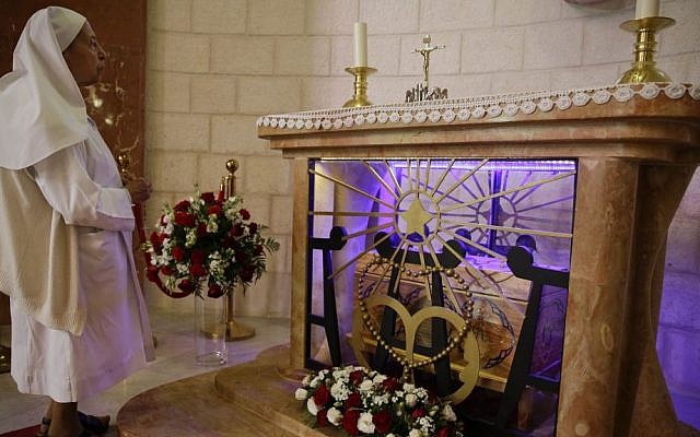 A nun stands by the tomb of Marie Alphonsine Ghattas, a nun who lived in what was Ottoman-ruled Palestine in the 19th century, at Church of the Rosary Sisters Mamilla in Jerusalem, on Saturday May 9, 2015. (Photo credit: Dusan Vranic/AP)