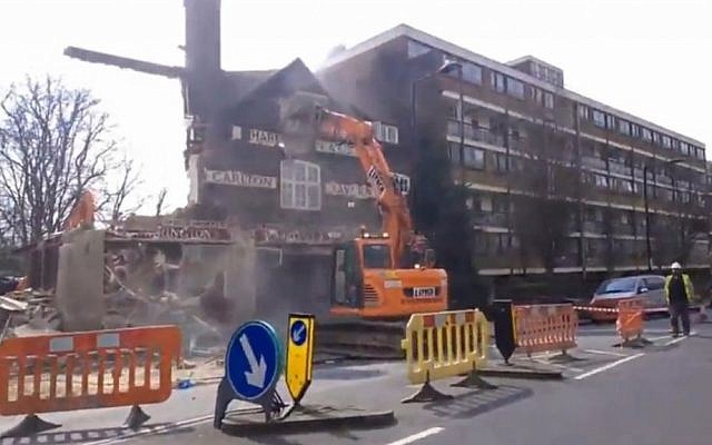 A screen shot of a Tel Aviv-based development firm demolishing the historic Carlton Tavern in Westminster, London without permission in April 2015. (screen shot: The Daily Mail)