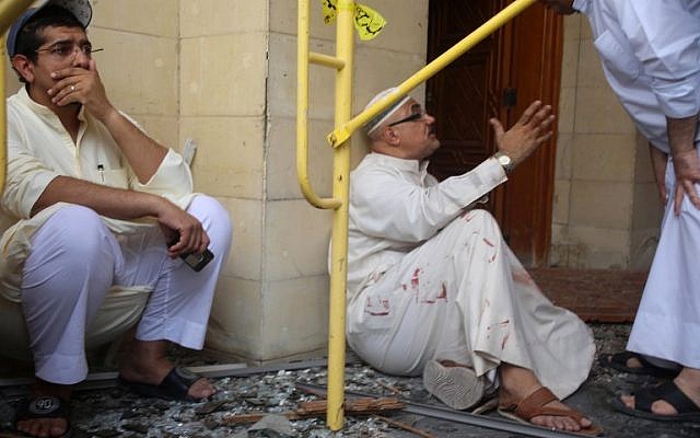 Kuwaiti men react at the site of a suicide bombing that targeted the Shiite Al-Imam al-Sadeq mosque during Friday prayers on June 26, 2015, in Kuwait City. (AFP PHOTO / YASSER AL-ZAYYAT)
