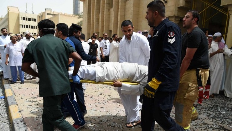 Kuwaiti security personnel and medical staff carry a man on a stretcher at the site of a suicide bombing that targeted the Shiite Al-Imam al-Sadeq mosque after it was targeted by a suicide bombing during Friday prayers on June 26, 2015, in Kuwait City. (AFP PHOTO / STR)