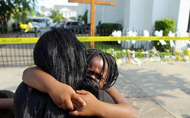 Kearston Farr hugs her 5-year-old daughter Taliyah visiting a memorial in front of the Emanuel AME Church on Friday, June 19, 2015 in Charleston, S.C.  (Curtis Compton/Atlanta Journal-Constitution via AP)