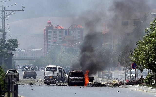 Fire and smokes rise at the site of a suicide attack during clashes with Taliban fighters in front of the Parliament, in Kabul, Afghanistan, Monday, June 22, 2015. (AP/Massoud Hossaini)