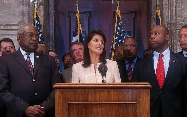 South Carolina Governor Nikki Haley speaks next to Congressman James Clyburn (L) and Senator Tim Scott (R) during a news conference in the South Carolina State House on June 22, 2015. (Tim Dominick/The State via AP)