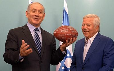 New England Patriots owner Robert Kraft gives Prime Minister Benjamin Netanyahu a signed football during a meeting with former players at the Prime Minister's Office in Jerusalem on June 22, 2015. (Amos Ben Gershom/GPO)