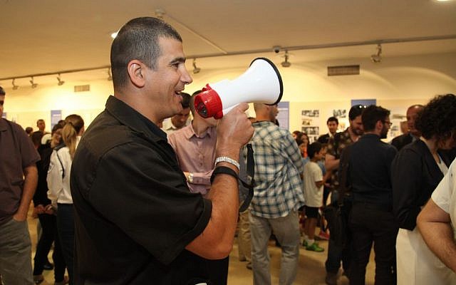 A man speaking instruction into a megaphone during a siren drill at the Knesset in Jerusalem on June 2, 2015. (Courtesy Knesset spokesperson)