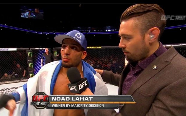 Noad Lahat after his Berlin win on Saturday night, draped in an Israeli flag (UFC screengrab)