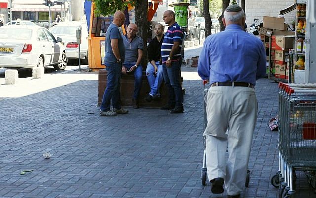 Pedestrians and shoppers go about their business on a popular Jerusalem street despite a siren wailing in a national Homefront Command drill on June 2, 2015. (Judah Ari Gross/Times of Israel)