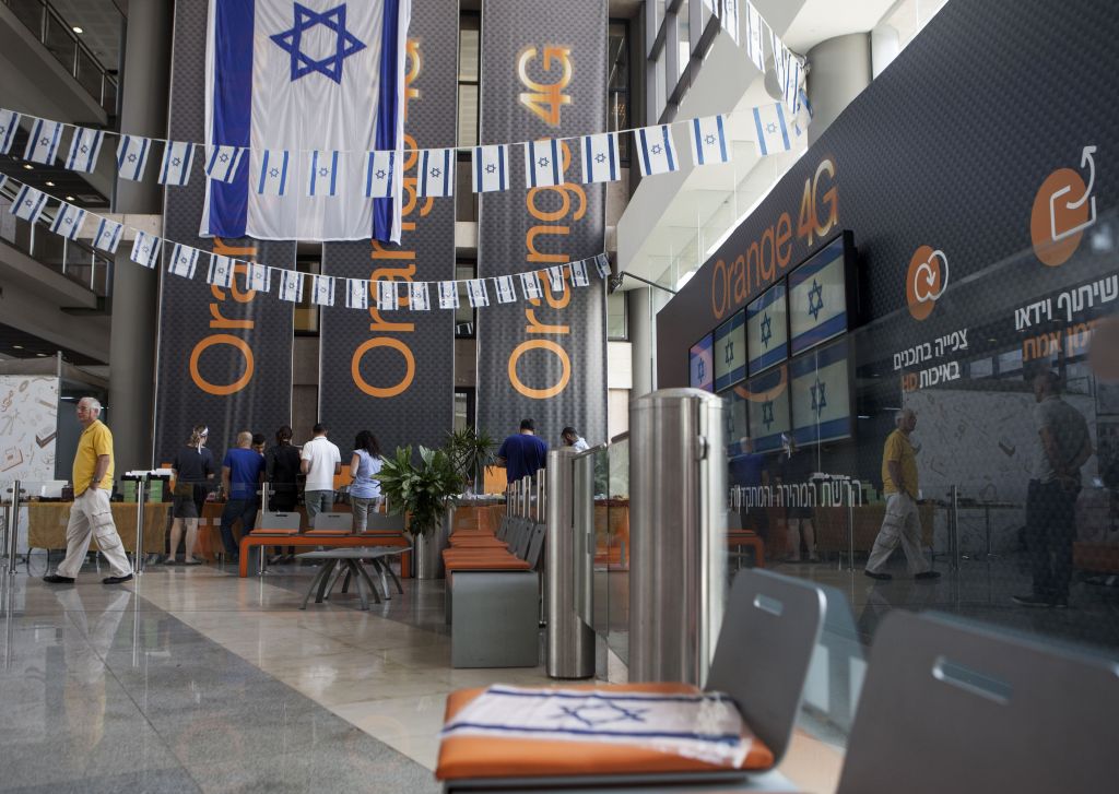 Israeli flags are seen inside the "Partner Orange" Communications Company offices in the city of Rosh Ha'ayin, Israel, Thursday, June 4, 2015. (AP Photo/Dan Balilty)