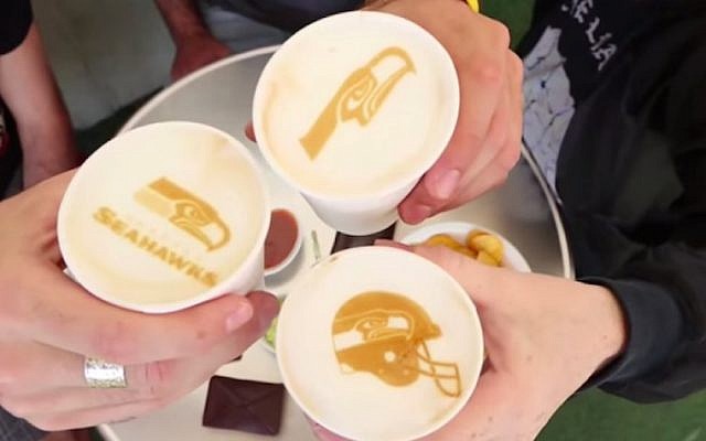 Football team logos printed onto cups of coffee by the Ripple Maker (Courtesy)