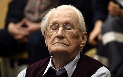 Convicted former SS officer Oskar Groening listens to the verdict of his trial on July 15, 2015 at court in Lueneburg, northern Germany. Oskar Groening, 94, sat impassively as judge Franz Kompisch said "the defendant is found guilty of accessory to murder in 300,000 legally connected cases" of deported Jews who were sent to the gas chambers in 1944. (AFP PHOTO/TOBIAS SCHWARZ)