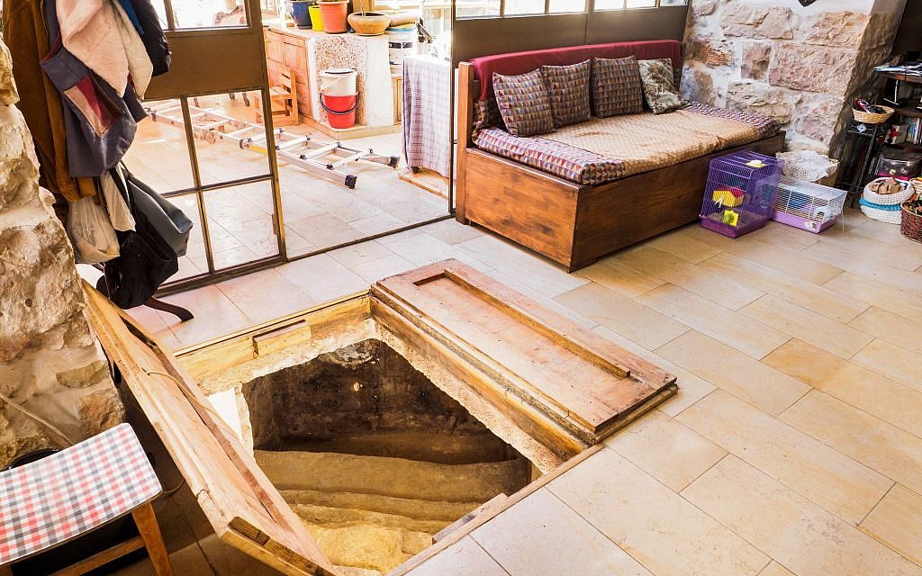A trap door in the Shimshoni's living room opening up to a ancient ritual bath. (Assaf Peretz/courtesy Israel Antiquities Authority)