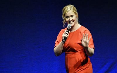 In this April 23, 2015, file photo, Amy Schumer, the writer and star of the upcoming film 'Trainwreck,' waves to the audience during the Universal Pictures presentation at CinemaCon 2015 at Caesars Palace in Las Vegas. (Photo by Chris Pizzello/Invision/AP, File)