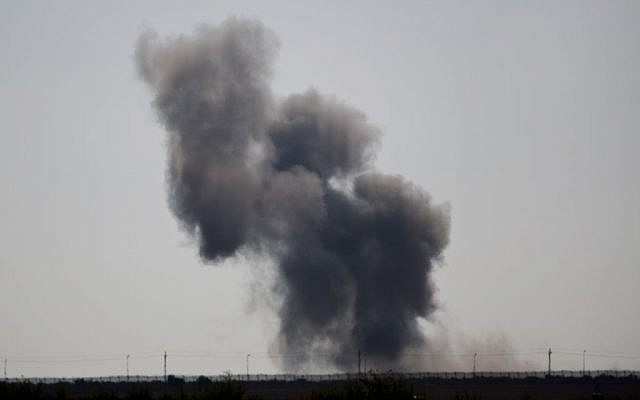 Smoke rises following an explosion in Egypt's northern Sinai Peninsula, as seen from the Israel-Egypt border, near Kerem Shalom in southern Israel, July 1, 2015. (AP/Ariel Schalit)